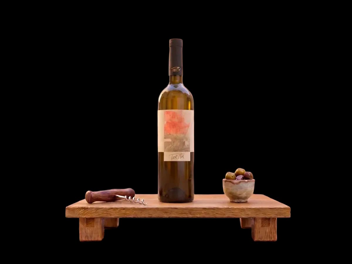 A bottle of Pošip Toreta from Korčula on a wooden stand, with a corkscrew and a bowl of olives